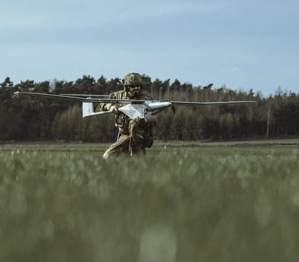 A soldier preparing to launch a WB Group FlyEye reconnaissance drone